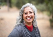 Older woman outside hiking and smiling